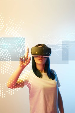 young woman in virtual reality headset pointing with finger at network illustration on beige and blue background clipart