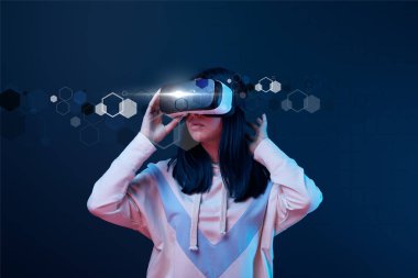 young woman in virtual reality headset among cyber illustration on dark background clipart