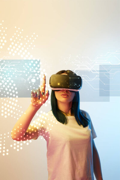 young woman in virtual reality headset pointing with finger at network illustration on beige and blue background