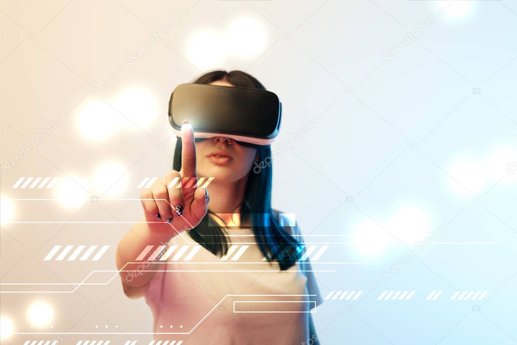 young woman in virtual reality headset pointing with finger at glowing network illustration on beige and blue background