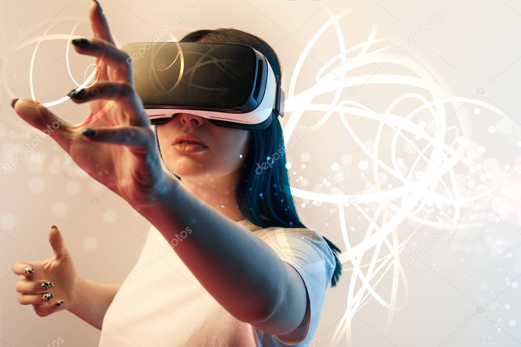 young woman in virtual reality headset gesturing among glowing cyber illustration on beige and blue background