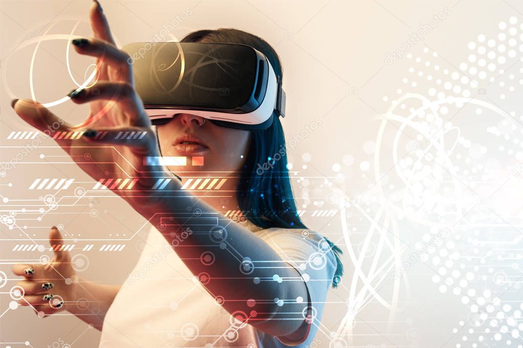 young woman in virtual reality headset gesturing with hands among glowing cyber illustration on beige background