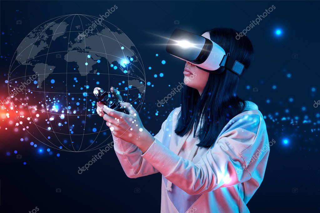 KYIV, UKRAINE - APRIL 5, 2019: Young woman in virtual reality headset using joystick on dark background with globe illustration