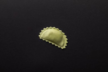 top view of green stuffed ravioli isolated on black with copy space clipart