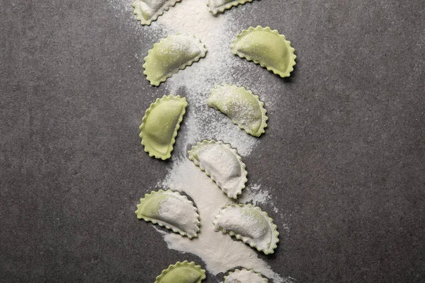 Top View Raw Green Ravioli Scattered Flour Grey Textured Surface — Stock Photo, Image