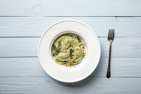 Top View Plate Green Ravioli Pine Nuts Sage Wooden Table — Stock Photo, Image