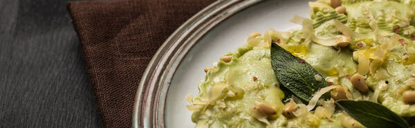 close up view of delicious green ravioli with sage, cheese and pine nuts, panoramic shot