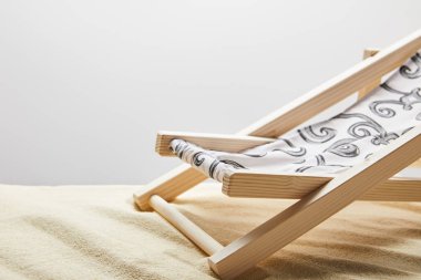 wooden deck chair on sand on grey background with copy space clipart
