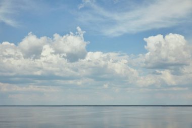 Landscape with light blue sky and river clipart