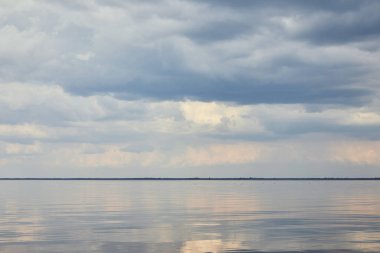 River over blue and peaceful sky with white clouds clipart