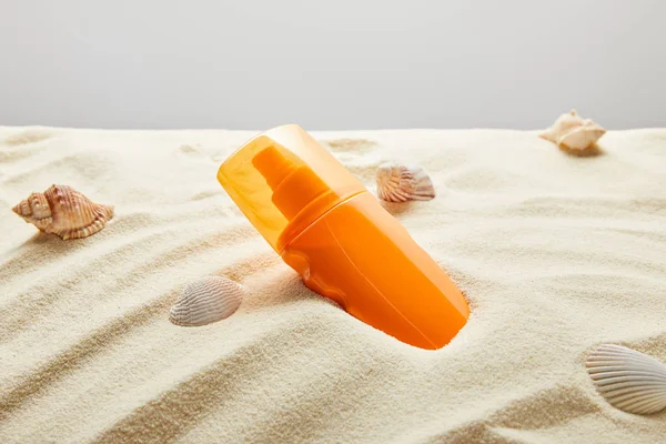 Sunscreen Orange Bottle Sand Seashells Grey Background — Stock Photo, Image