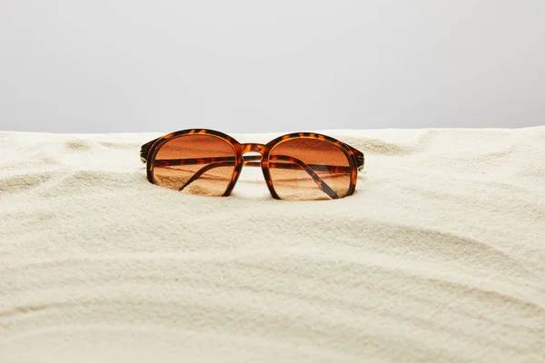Brown Stylish Sunglasses Sand Grey Background — Stock Photo, Image