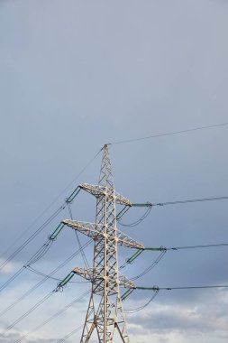 low angle view of electric pole with wires on grey cloudy background  clipart