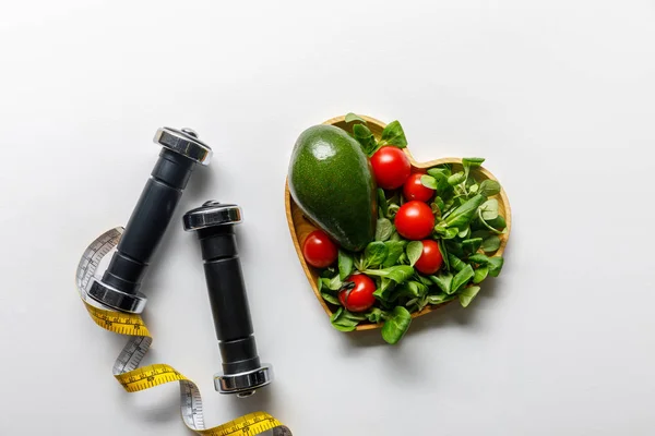 Top View Vegetables Heart Shaped Bowl Measuring Tape Dumbbells White — Stock Photo, Image