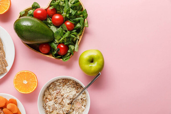 top view of fresh diet food on pink background with copy space