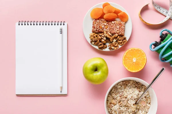 新鮮なダイエット食品のトップビュー 測定テープ コピースペースとピンクの背景にロープと空白のノートブックをスキップ — ストック写真