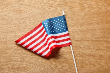 close up view of american flag on wooden table clipart