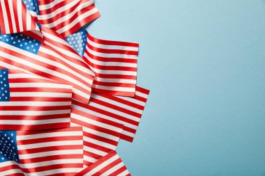 kopya alanı ile sopa mavi arka plan üzerinde Amerikan bayrakları yığınının üst görünümü