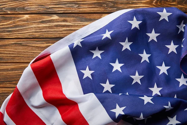 top view of american flag on wooden brown surface 