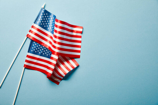 top view of national american flags on blue background with copy space
