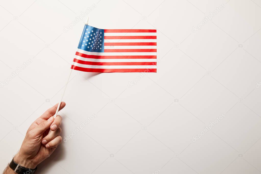 top view of man holding american flag on white background 