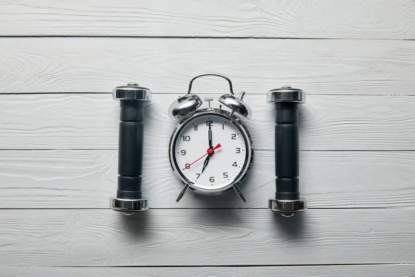 Flat Lay Silver Alarm Clock Black Dumbbells Wooden White Background — Stock Photo, Image