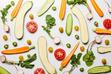 top view of fresh sliced vegetables on white background clipart