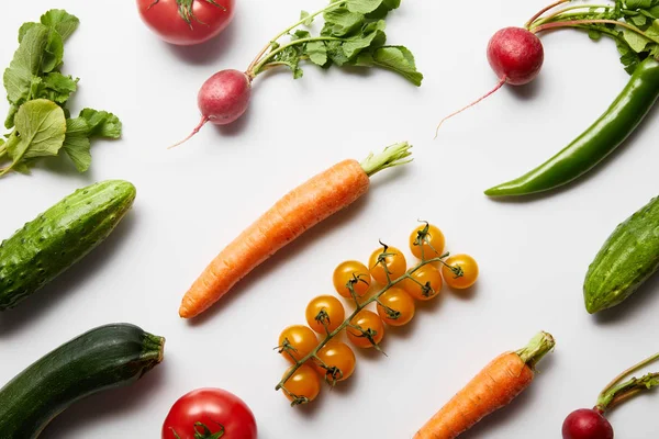 top view of fresh whole organic vegetables on white background