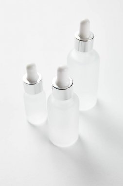 beyaz serum ile üç cam şişe 