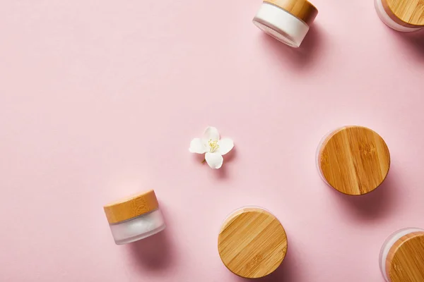 Top View Scattered Jars Cream Wooden Caps Jasmine Flower Middle — Stock Photo, Image