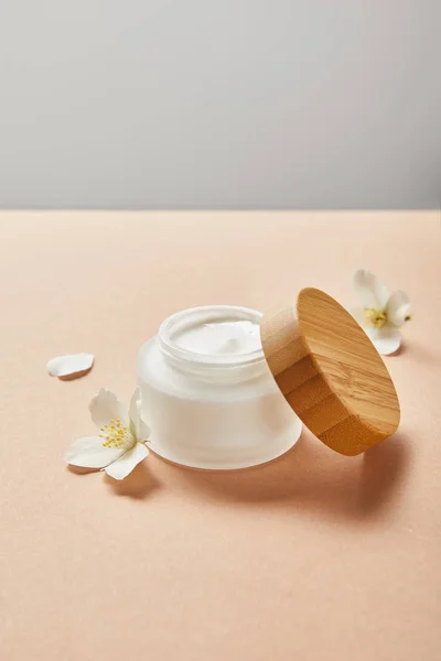 Open Jar Cream Wooden Cap Few Jasmine Flowers Beige Isolated — Stock Photo, Image
