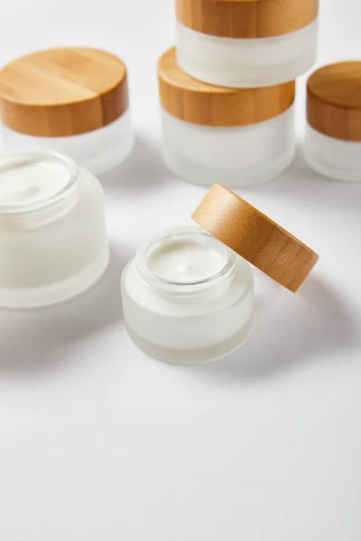 Glass Jars Cream Wooden Caps White — Stock Photo, Image