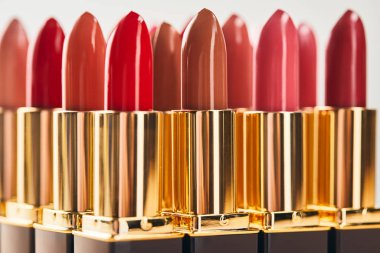 various red shades of lipsticks isolated on grey  clipart