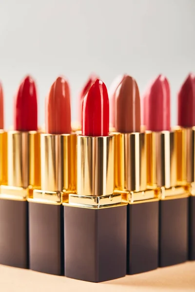 Various Red Lipsticks Beige Grey — Stock Photo, Image