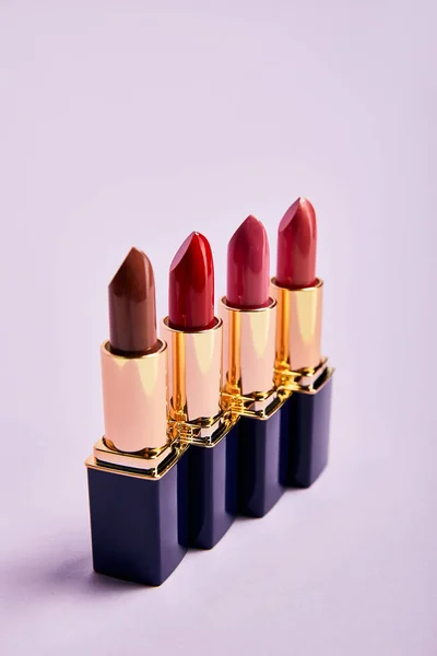 Various Red Lipsticks Tubes Violet — Stock Photo, Image