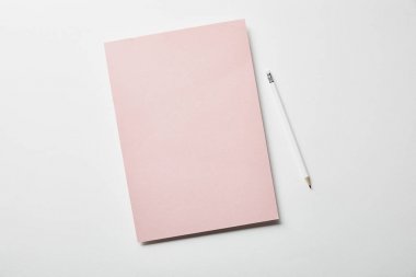 top view of pink paper and pencil on white surface clipart