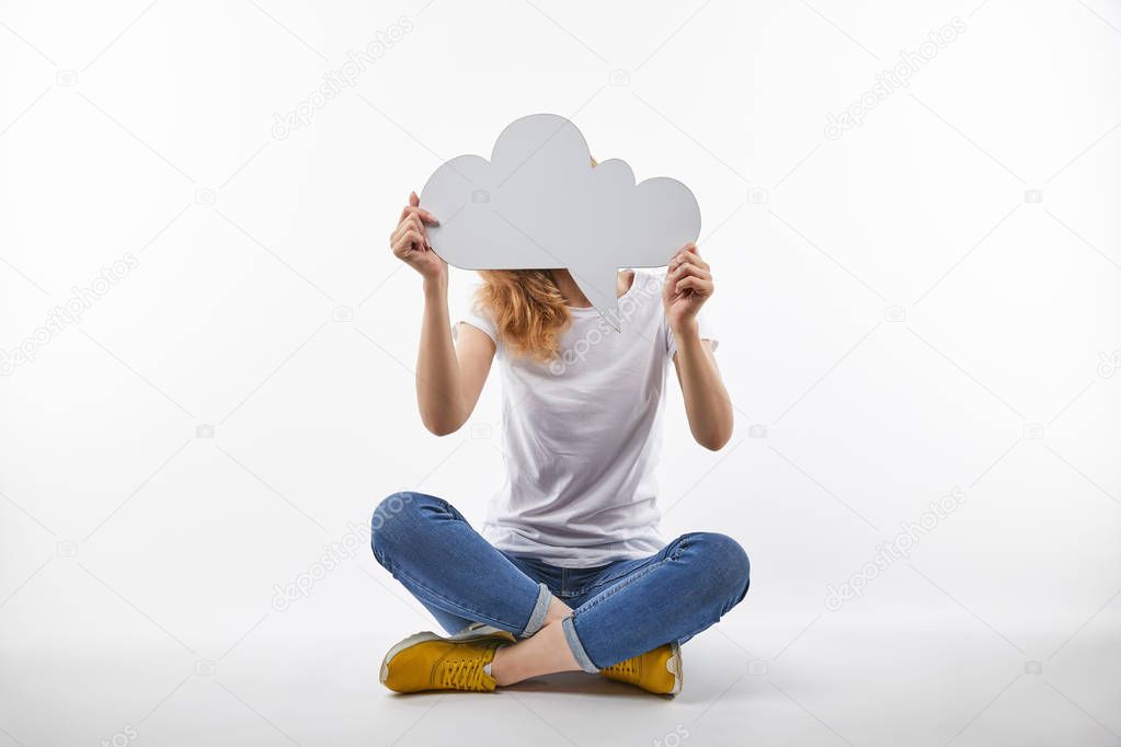 woman with thought bubble in hands sitting isolated on white