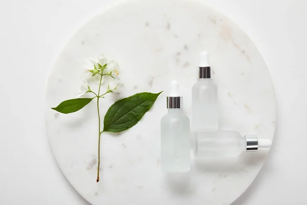Top View Plate Jasmine Cosmetic Glass Bottles White Surface — Stock Photo, Image