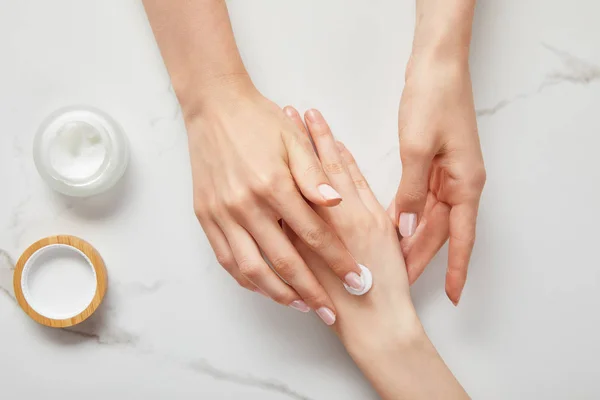 Cropped View Woman Applying Cream Hand Using White Moisturizer Jar — Stock Photo, Image