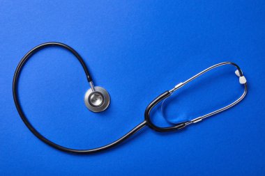 top view of stethoscope on blue background clipart