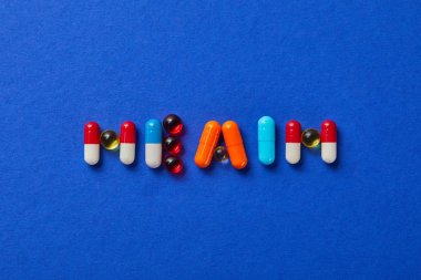 mavi arka plan üzerinde çeşitli haplar yapılan kelime sağlığı üst görünümü