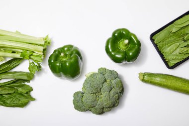 top view of green organic vegetables on white background clipart