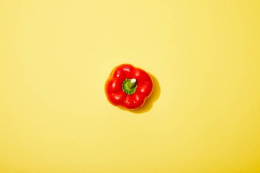 top view of red paprika on yellow background clipart