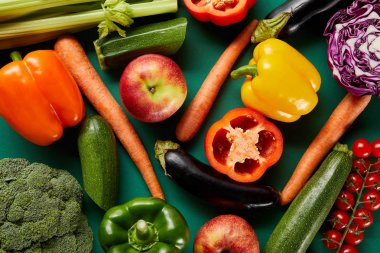 top view of colorful fresh vegetables on green background clipart