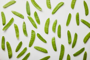 top view of green peas scattered on white background clipart