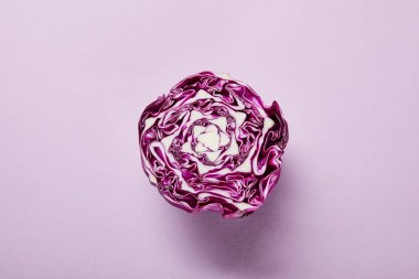top view of ripe red cabbage on violet background with copy space clipart