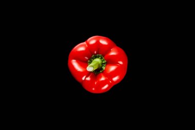 top view of fresh organic red paprika isolated on black clipart