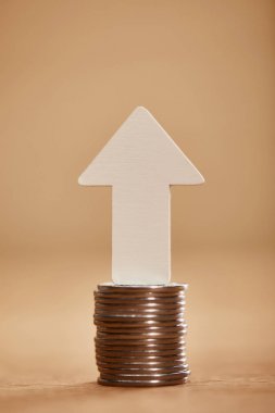 stack of coins with white arrow upwards, financial growth concept clipart
