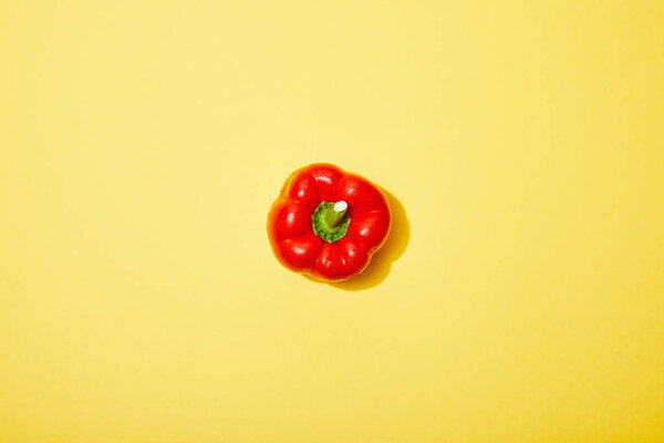 top view of red paprika on yellow background