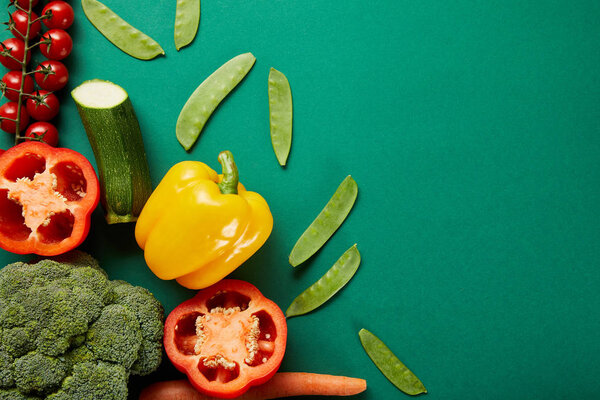 top view of fresh vegetables on green background with copy space